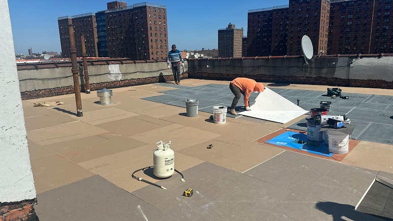New roofing system installation with cover board across roof area